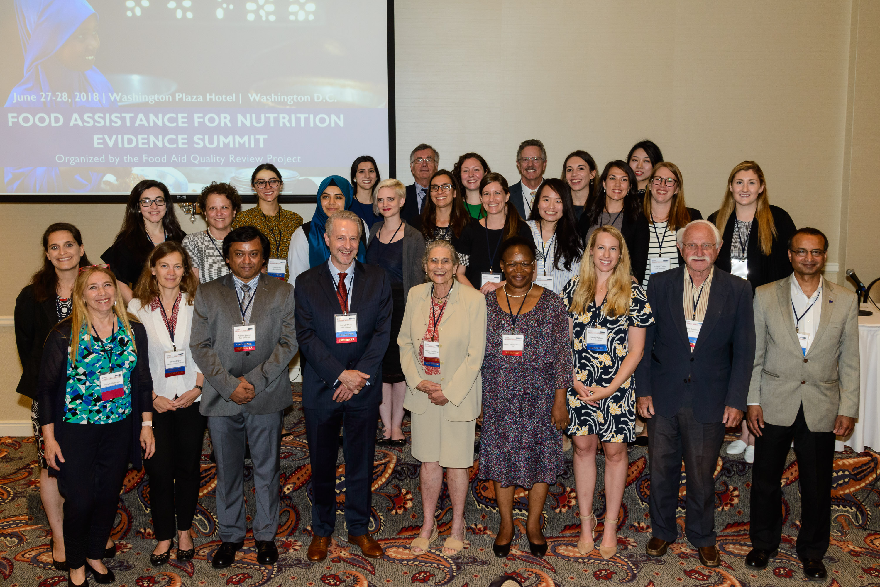 Faculty members Patrick Webb, Bea Rogers, and Irv Rosenberg gather with staff and summit participants